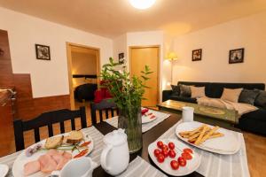 a living room with a table with food on it at Apartmány Sonáta Luhačovice in Luhačovice
