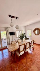 a dining room with a wooden table and chairs at Villa in Nature with Yoga Room, Peace and Tranquility in Puigpunyent