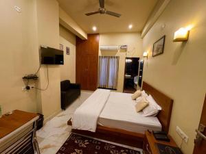 a hotel room with a bed and a television at Green hillock hotel in Alwar