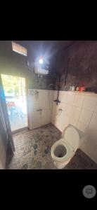 a bathroom with a toilet in a room at Family Hostel Lovina in Lovina +44 photos