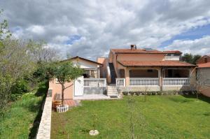 a house with a white fence and a yard at Lavanda Haus in Vodnjan