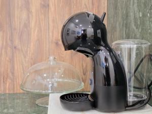 a coffee maker sitting on a counter next to a glass container at Monção Golden I I in Monção