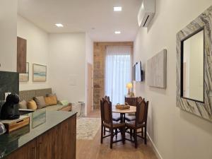 a kitchen and living room with a table and chairs at Monção Golden I I in Monção +19 photos