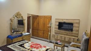 a living room with a mirror and a television at Hotel Destination in Sukkur +14 photos