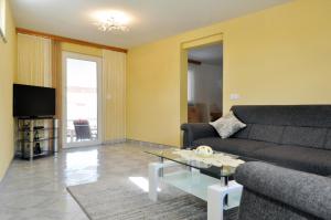 a living room with a couch and a coffee table at Lavanda Haus in Vodnjan