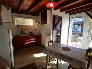 a kitchen with a table and a kitchen with a refrigerator at Gîtes & chambre d'Hôtes - AVEZE in Avèze
