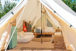a bedroom with a tent with two beds at Kampaoh Praia do Meco in Sesimbra