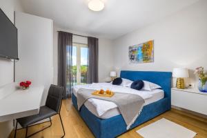 a bedroom with a blue bed with a table and a chair at Villa Bartol in Trviž +46 photos