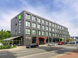 a large building on a street with cars parked outside at ibis Styles Vechta in Vechta