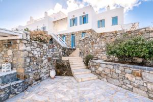 a stone wall and stairs in front of a house at Lunar Villa in Glastros