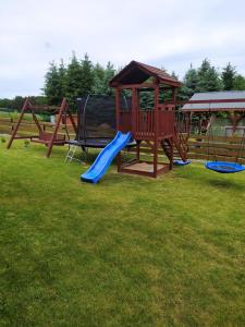 a playground with a slide and a gazebo at Dom letniskowy Krzyś in Przejma Wielka