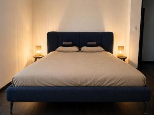 a blue bed with two pillows on top of it at Downtown Velvet Loft in Brussels