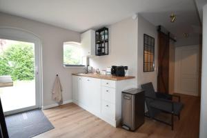 a kitchen with a counter and a chair in a room at De Vechthoeve in Dalfsen +31 photos