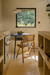 a table and a chair in a kitchen with a window at Casa Calma in Čenkovice