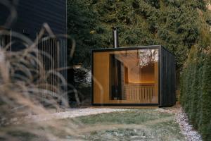 a glass box sitting on the side of a yard at Casa Calma in Čenkovice +24 photos