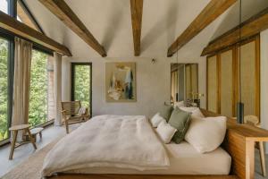 a bedroom with a large bed and large windows at Casa Calma in Čenkovice