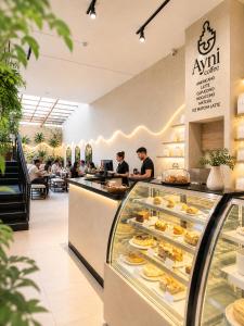 a restaurant with people sitting at a counter with pastries at Ayni Living - Hostel in Lima