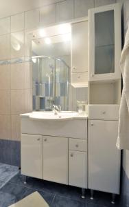 a white bathroom with a sink and a mirror at Lavanda Haus in Vodnjan +16 photos