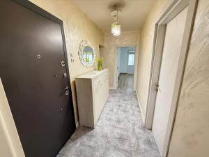 a bathroom with a black door and a sink at Catherdral Apartments with Parking in Varna City +7 photos