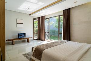a bedroom with a large bed and a large window at Oyama City View Villa 4 Bedrooms With a Private Heated Swimming Pool and a Billiard Table in Bandung