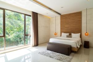 a bedroom with a bed and large windows at Oyama City View Villa 4 Bedrooms With a Private Heated Swimming Pool and a Billiard Table in Bandung +29 photos