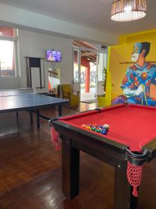 a room with a pool table and a painting at RioVermelhopoint in Salvador