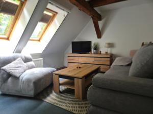 a living room with a couch and a table at Speck 5 klein in Kargow +14 photos