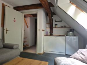 a living room with a staircase and a kitchen at Speck 5 klein in Kargow
