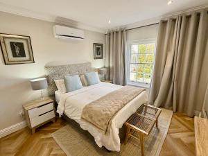 a bedroom with a large bed and a window at Anesta House in Stellenbosch +30 photos