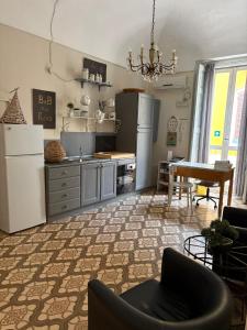 a kitchen with a refrigerator and a table at Dimora Via Roma in San Severo