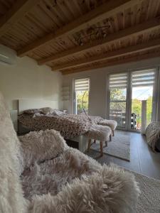 a bedroom with two beds and a wooden ceiling at Pop Apartment Kerepes in Kerepes