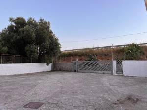 a parking lot with a gate and a fence at Residence Il Pantheon - Fuscaldoapartment in Marina di Fuscaldo