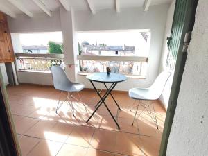 a balcony with a table and two chairs in a room at Bonlogem - Air-conditioned apartment Sainte Claire in Pertuis