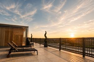 a balcony with a view of the sunset at Luma Hotel Spa&Fitness in Fulda