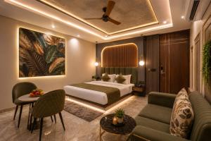 a hotel room with a bed and a couch at Hotel Premium Suites-Free Airport Pickup in New Delhi