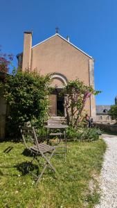 a bench and a table in front of a church at Escales patrimoniales en cœur de ville in Poitiers