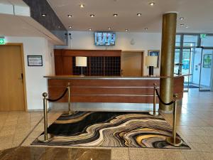 a lobby with a bar in a building at City Best Autobahnhotel Stolper Heide in Berlin