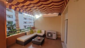 a living room with a couch and a large window at Apartamento junto al mar in Vera