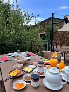 a table with breakfast food and drinks on a balcony at Colmeal Countryside Hotel in Figueira de Castelo Rodrigo +29 photos