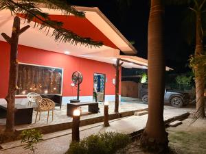 a house with a table and chairs in front of it at TAG Farm in Greater Noida