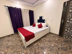 a bedroom with a bed with red pillows on it at TAG Farm in Greater Noida