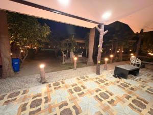 a room with a cross on a floor with candles at TAG Farm in Greater Noida