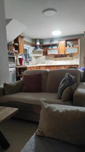 a living room with a couch and a kitchen at בית שבט אחים in Hatzor haglilit