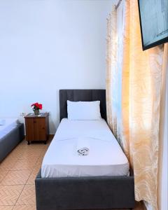 a small bed in a room with a bed frame at MARE Hotel Velipoje in Shkodër