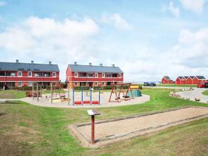 a playground in front of a red building at Lemvig Coastal Stay in Lemvig +45 photos