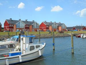 a boat docked in the water in front of houses at Lemvig Coastal Stay in Lemvig