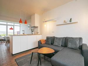 a living room with a couch and a table at Lemvig Coastal Stay in Lemvig