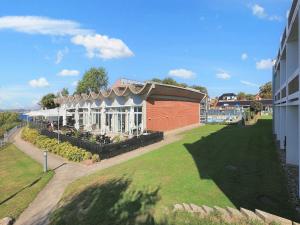 a building with a lawn in front of a building at Faaborg Holiday Center in Faaborg