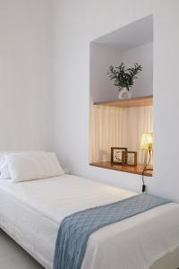 a bedroom with a bed with a mirror above it at Lydía Residence - Mantoudi Evia in Mantoúdion