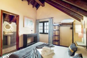 a bedroom with a bed and a bathroom with a sink at Sunset Village in São Jorge